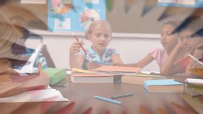 Animation of crayons rotating over happy caucasian boy learning with diverse pupils at school. elementary school education and learning concept digitally generated video.
