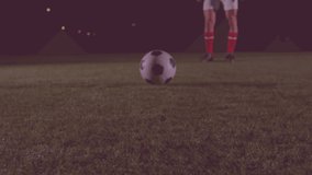 Animation of globe rotating with network of connections over legs of caucasian male soccer player. global sports, connections and technology concept digitally generated video.