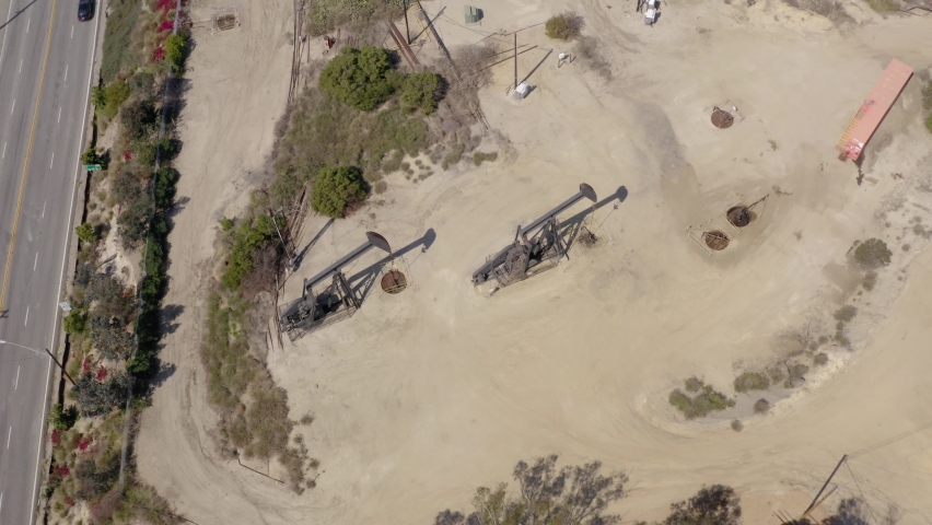 Oil rigs working in field at daytime. Oil pump jack on the factory.   Aerial view oil refinery factory. Aerial view of Oil Pumpjack. Industry equipment.