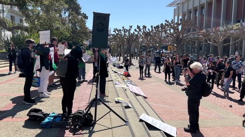 Berkeley, CA - March 8, 2022: 4K HD video panning across participants; spectators and counter protestors at Rise Up 4 Abortion Rights protest in Sproul Plaza at UC Berkeley, CA.
