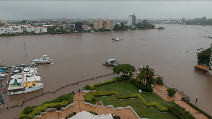 A tug boat heads up the Brisbane River during the relentless rain deluge that led to the 2022 Brisbane floods.