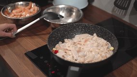 woman frying seafood in a frying pan.video in 4k.
