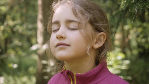 Healthy Lifestyle Harmony Enjoying. Calm Little Child Taking Deep Breath of Fresh Air on Nature. Portrait of Child Girl Inhaling and Exhaling Fresh Air, Taking Deep Breath, Reducing Stress. 