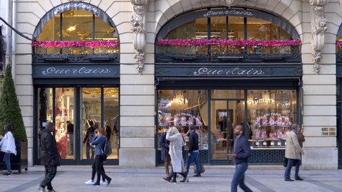 Paris, France - May 2019 : People walking in front of the Guerlain store on the Champs-Elysees avenue in Paris, France