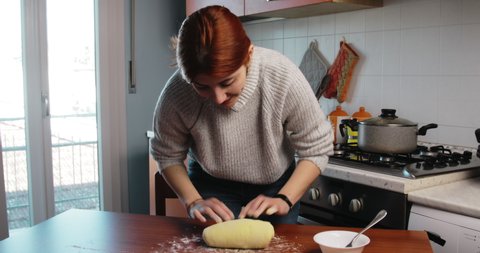 Young Italian girl is kneading the potato dough for the homemade gnocchi