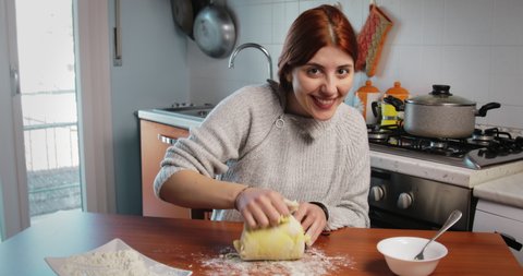 Smiling Young girl is making homemade potato Italian gnocchi