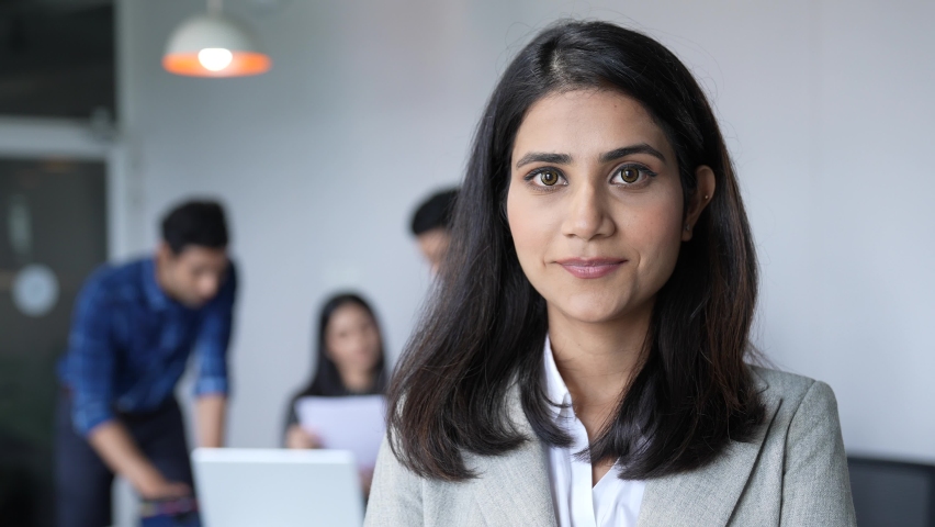 Beautiful smiling confident young indian ethnic woman pretty face looking at camera posing home in office, happy millennial hindu ethnicity girl student professional close up front portrait. Royalty-Free Stock Footage #1088116305
