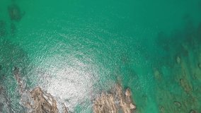 Aerial view Drone camera of seashore rocks in ocean. Beautiful sea surface. Amazing sea waves crashing on rocks seascape in Phuket island Thailand. Aerial view drone 4k High quality footage