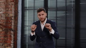 A young guy in a classic suit dances and money rains on him. Concept of success - Powered by Shutterstock - Get 15% off with code: PIKWIZARD15