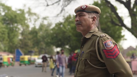 Delhi, India- Feb 16, 2022: Delhi Police   on duty for safety in a busy road in Mehrauli, Delhi India.