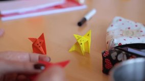 Close up detail shot of a skilled white caucasian woman folding and origami, creating origami fox, oriental traditional Japanese art on a wooden desktop - Powered by Shutterstock - Get 15% off with code: PIKWIZARD15