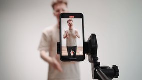 Male Blogger Shoots a Blog on a Smartphone. Influencer Broadcasts Using his Phone. Concept of Online Communication. Remote Work via the Internet. 