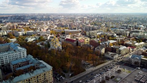 Kharkiv, Ukraine - October 20, 2021: Aerial autumn tourist attractions on Sumska street in Kharkiv city center. Mirror Stream, Church with golden dome, recreational area, park and sights rooftop