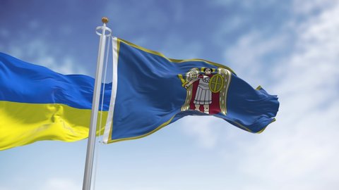 the city flag of Kiev with the depiction of the Archangel Gabriel waving with the Ukrainian national flag. The patron Saint of Kyiv Archangel Michael holding a flaming sword
