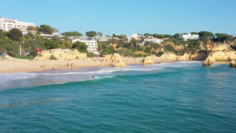 Aerial view of beautiful Portuguese beaches with rocky sandy shores and pure sand for tourists' recreation in the Algarve in the south.