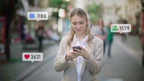 Young Blonde Caucasian Woman Using Smartphone to Check her Social Media Account. Animated Social Media Icons. Social Network Concept. Likes, Comments and Followers Counter. City Daytime. - Powered by Shutterstock - Get 15% off with code: PIKWIZARD15