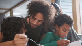 Slow motion of father helping son eat breakfast - Powered by Shutterstock - Get 15% off with code: PIKWIZARD15