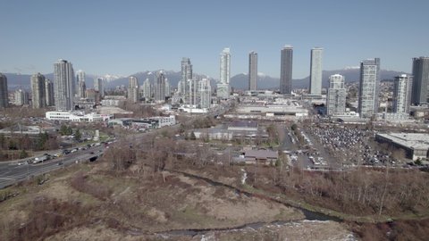 Burnaby highway with skyscrapers in background, Lower Mainland region of British Columbia, Canada. Aerial sideways