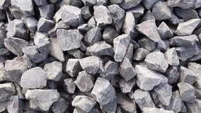 Gravel of large fractions Crushed stone building aggregate stone structure. The pile of building material. Crushed Stone close-up Lies on the ground. Breakstone. Granite gravel construction materials.