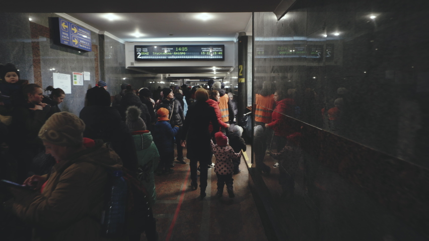 Lviv, Ukraine - March 15, 2022: Ukrainian refugees on Lviv railway station waiting for train to escape to Europe. Crowd of people. War in Ukraine concept
