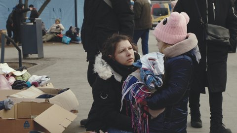 Lviv, Ukraine - March 15, 2022: Mother and daughter. Refugees from Ukraine helped by volunteers. War at Ukraine concept. Editorial Stock Footage