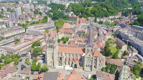 Inscription on video. Lausanne, Switzerland. Cathedral of Lausanne. La Cite is a district historical centre. Text furry, Aerial View, Departure of the camera