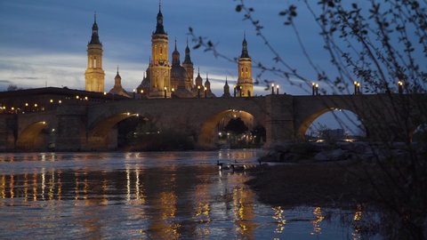 
4k video of the sunset in Zaragoza, the blue hour next to the Pilar basilica and next to the Piedra bridge in Zaragoza, Aragón. Spain.
