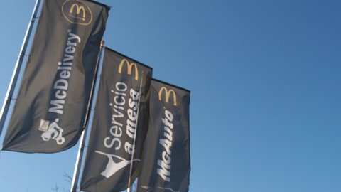 Estepona, Spain -February 21, 2022: Advertising flags waving from McDonald's fast food restaurant