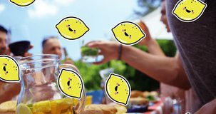Animation of lemon icons over diverse friends at table with drinks. world cocktail day and celebration concept digitally generated video.