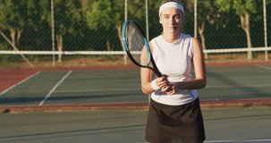 Video of happy caucasian female tennis player holding racket and hitting ball. professional tennis training, sport and competition concept.
