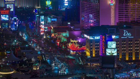 Las Vegas, Nevada, USA - February 16, 2022: Night Time-lapse of traffic on the Las Vegas Strip near the Flamingo. 