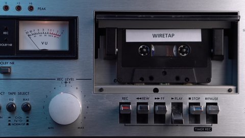 Vintage Audio Cassette Tape With Wiretap Recording Rolling in Deck Player, Close Up