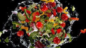 Super slow motion shot of rotating exploded Salad and splashing water on black at 1000fps. - Powered by Shutterstock - Get 15% off with code: PIKWIZARD15