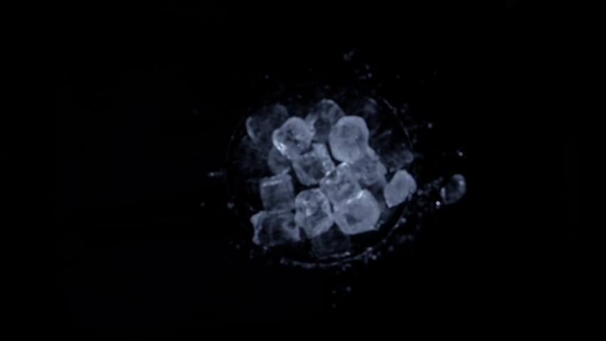 Super slow motion shot of rotating exploded Ice Cubes and splashing water on black at 1000fps. | Shutterstock HD Video #1088143585