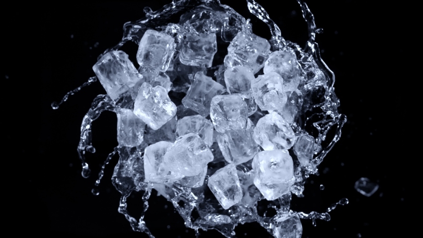 Super slow motion shot of rotating exploded Ice Cubes and splashing water on black at 1000fps. Royalty-Free Stock Footage #1088143585