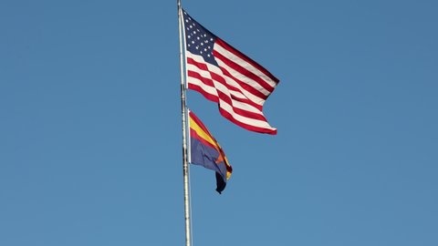 American flag and Arizona State flag blowing in the wind.