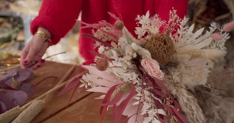 Professional Florist Arranging Materials Of A Dried Flowers Bouquet In Floral Shop. Close Up