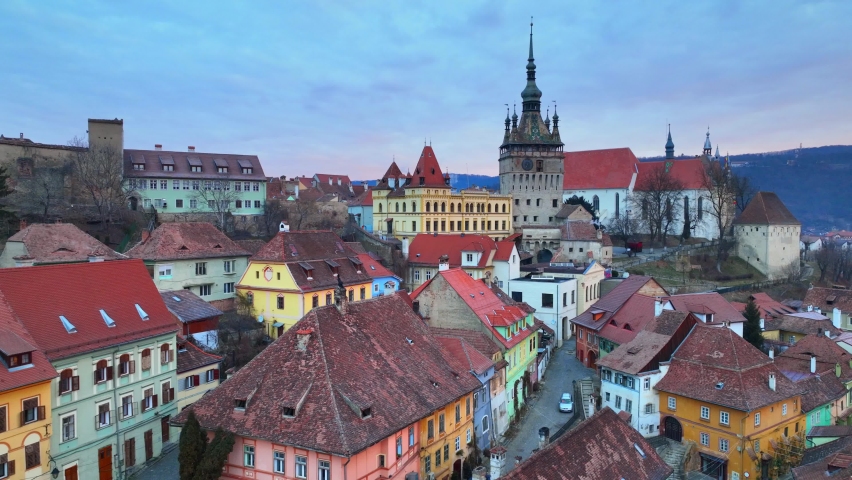 historic medieval town of Sighisoara, aerial view, famous tourist destination in Romania, scenic unesco heritage site in Transylvania in winter. High quality 4k footage