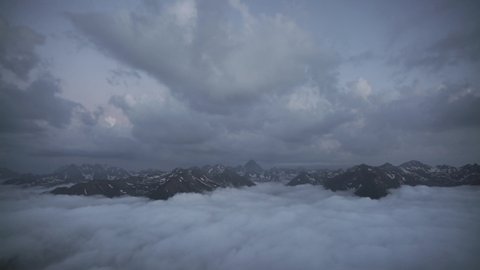 8K 7680x4320 4320p.High rocky snowy mountains between two different cloud layers.Pyrenees is a mountain range straddling the border of France and Spain.Cantabrian mountains range.Above clouds over 8K.