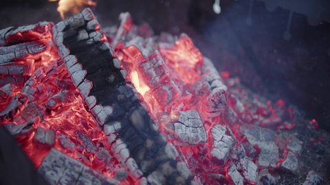 Closeup of barbecue brazier grill with extinct charcoal, coal for preparing shashlik or shish kebab. Skewered roasted kebabs on BBQ grill