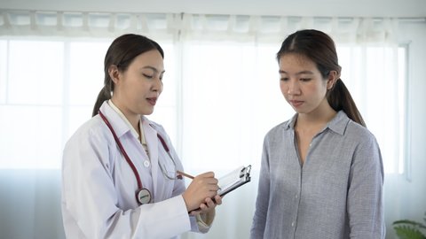 4K, An Asian female doctor uses a stethoscope against the patient's chest to listen to the heart sound to know the patient's condition.	
