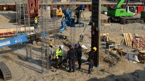 Blankenberge, west-Flanders, Belgium - March 04, 2022: work in progress. Iron poles. Foundations to construct a mold to pour into concrete pillars.
