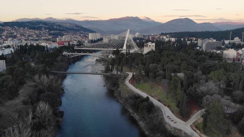 Podgorica , Montenegro - 01 25 2022: Union Bridge, Millennium Bridge, and Blaza Jovanovica crossing the Moraca river - Drone footage