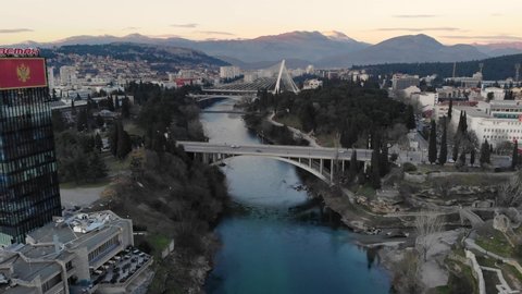 Podgorica , Montenegro - 01 25 2022: Stationary Cinematic Aerial Shot of the Moraca River and the cityscape of Podgorica in Montenegro after Sunset