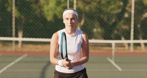 Video of focused caucasian female tennis player holding racket and hitting ball. professional tennis training, sport and competition concept.