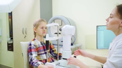 ophthalmologist examines girl on corneal topographer. Videokeratograph is medical device for determining curvature of cornea. mandatory device for modern clinic or opticians shop.