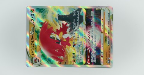 Hamburg, Germany - 03122022: video of the japanese card Hisui Silvarro VSTAR from the set Battle Region. Led light moves over pokemon trading card to show the shiny rainbow surface.