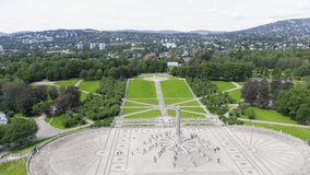 Inscription on video. Oslo, Norway. Public park in the city of Oslo. Aerial view. Different colors letters appears behind small squares, Aerial View, Departure of the camera