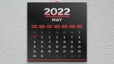 Close-up of a black beautiful May page of the wall calendar 2022 and the camera moves to Eid al-Fitr date marked red