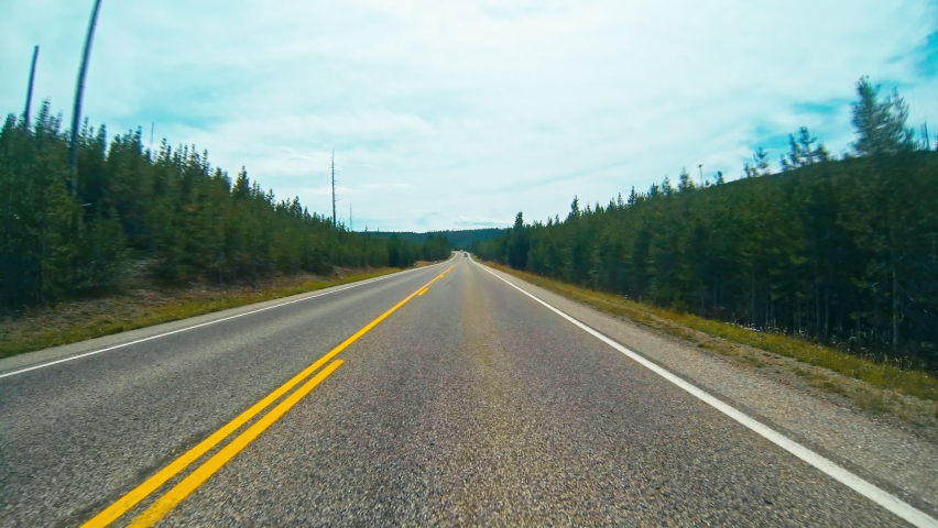 Timelapse hyperlapse of driving around forests and mountains, in Yellowstone national park.